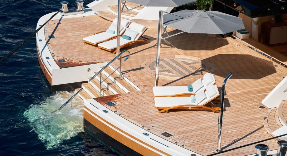 Introduction to Yacht Design | YATCO Luxury yacht deck with lounge chairs and ocean view.
