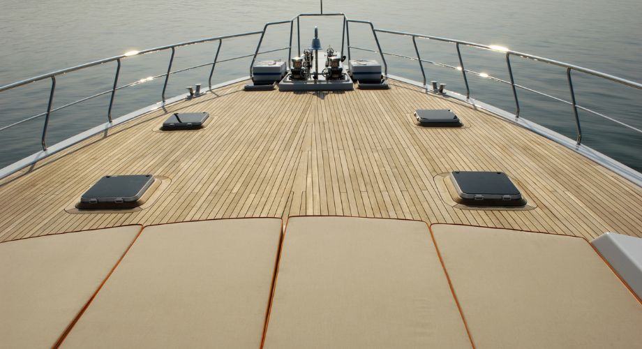 Yacht Deck | YATCO An outdoor wooden yacht deck of a yacht sailing in the ocean.