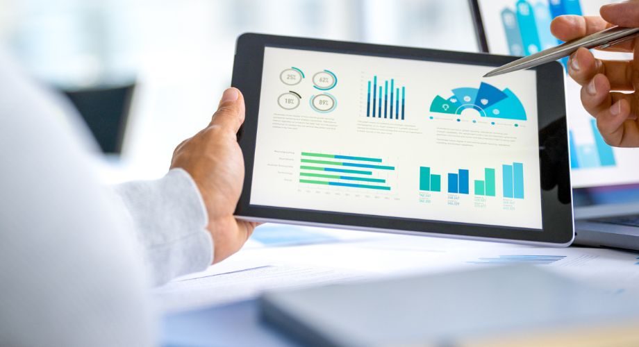 Yacht Investment | YATCO A man checking the financial charts on an iPad.